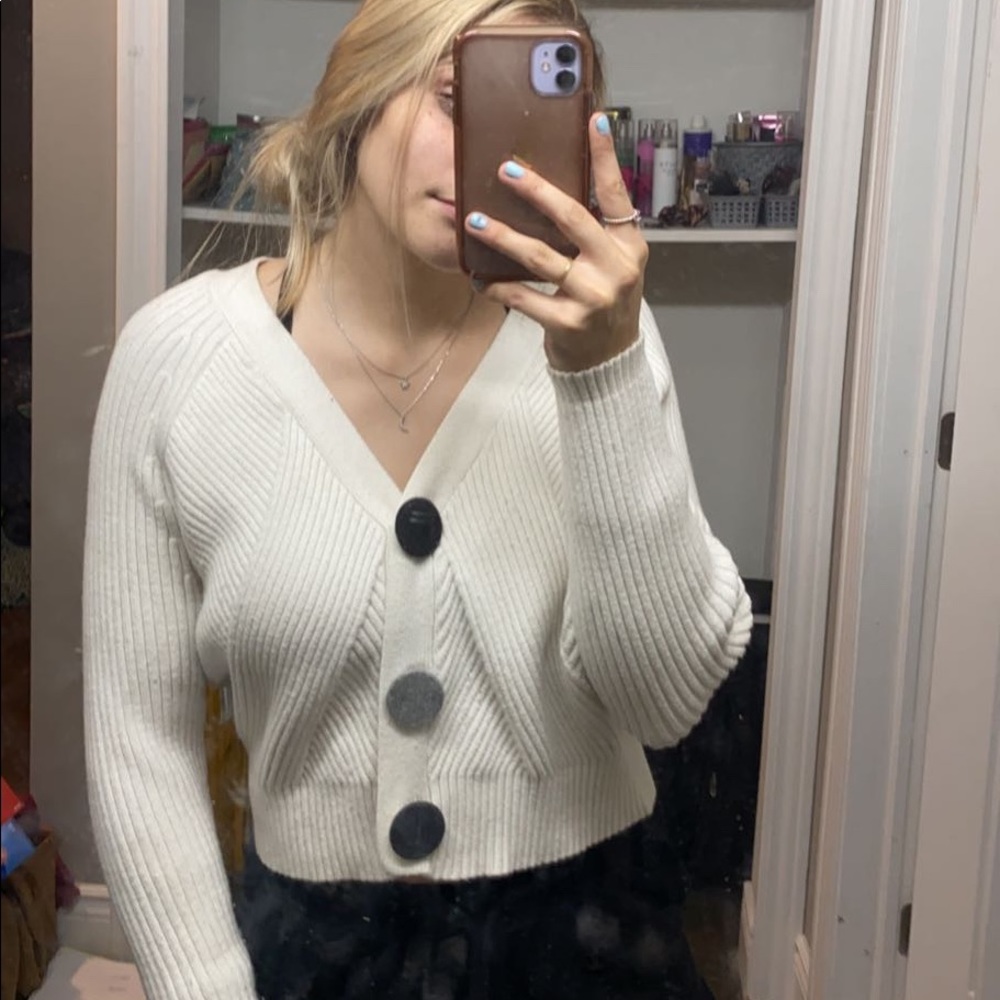 white sweater with felt buttons